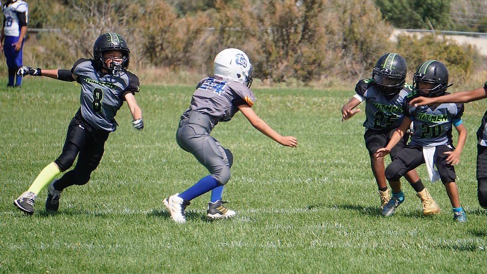 Mark Perkins (8), Kylin Jackson (25) and Hayden Lopez of the Prescott Valley Hitmen Minors team attempt to make the tackle during their game against Bagdad on Saturday, Sept. 28, 2019, at Bradshaw Mountain Middle School. (Aaron Valdez/Courier)