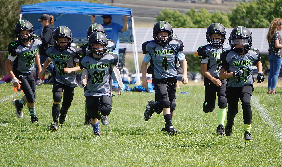 The Prescott Valley Hitmen Minors team storms the field during their game against Bagdad on Saturday, Sept. 28, 2019, at Bradshaw Mountain Middle School. (Aaron Valdez/Courier)