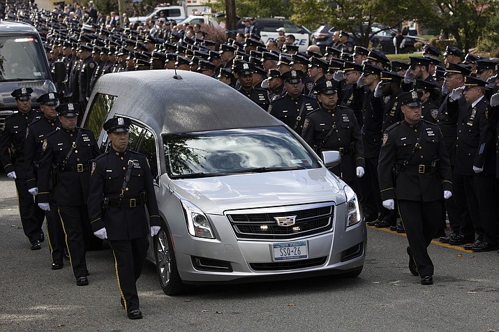 The hearse bearing New York City Police Officer Brian Mulkeen leaves the Church of the Sacred Heart following a funeral Mass, Friday, Oct. 4, 2019, in Monroe, N.Y. Authorities say Mulkeen was fatally hit Sunday by two police bullets while struggling with an armed man in the Bronx. He is the second New York City officer killed by friendly fire this year. (AP Photo/Mark Lennihan)