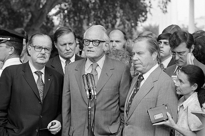 In this Aug. 7, 1974 photo, Sen. Barry Goldwater, R-Ariz., center, speaks to reporters after meeting with President Richard Nixon at the White House to discuss Nixon's decision on resigning. Flanked by Senate Republican Leader Hugh Scott of Pennsylvania, left and House GOP Leader John Rhodes of Arizona, right, Goldwater said Nixon has made "no decision" on whether to resign. The three top Republican leaders in Congress paid a solemn visit to Nixon, bearing the message that he faced near-certain impeachment due to eroding support in his own party on Capitol Hill. Nixon, who’d been entangled in the Watergate scandal for two years, announced his resignation the next day. (AP Photo, file)
