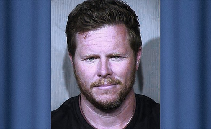 This undated booking photo provided by the Maricopa County Sheriff's Office shows County Assessor Paul Petersen, who has been indicted in an adoption fraud case. Petersen is accused of arranging for dozens of pregnant women from the Marshall Islands to come to the U.S. to give their children up for adoption. Utah also has charged him with 11 felony counts, including human smuggling, sale of a child and communications fraud. (Maricopa County Sheriff's Office via AP)