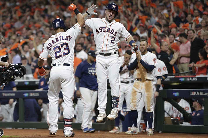 Houston Astros' Michael Brantley (23) celebrates his solo home run against the Tampa Bay Rays with Alex Bregman (2) during the eighth inning of Game 5 of a baseball American League Division Series in Houston, Thursday, Oct. 10, 2019. The Astros won 6-1, and will face the New York Yankees in the AL Championship Series. (Michael Wyke/AP)