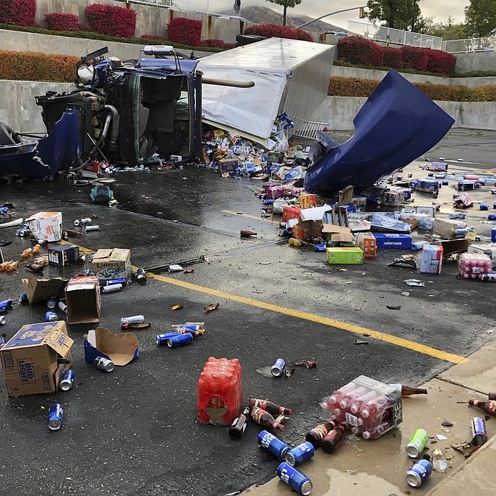 A semi-trailer driver, hauling beer, suffered serious injuries after his vehicle rolled over and crashed in a parking lot of a church, Thursday morning, Oct. 10, 2019, in Sandy Utah. Cans of beer have littered the parking lot of a church of The Church of Jesus Christ of Latter-day Saints in a Salt Lake City suburb after a semi-trailer crashed that was carrying cases of brew banned by the faith.(Derek Petersen/KSL-TV - The Deseret News via AP)