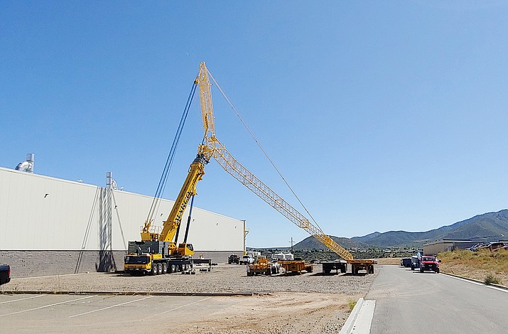 Printpack, 6800 E. 2nd St. in Prescott Valley, has been using a tall, yellow crane, as seen standing here Oct. 2, 2019, on the plant’s west side, to remove and replace its rooftop HVAC units. (Doug Cook/Courier)