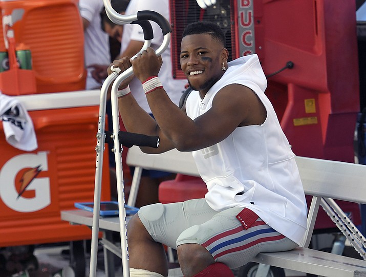 New York Giants running back Saquon Barkley smiles as he sits on the bench during the second Sept. 22, 2019, in Tampa, Fla. Barkley was injured in the first half. On Friday, Oct. 18, it was announced the Barkley was clear to play against the Arizona Cardinals this Sunday. (Jason Behnken/AP, file)