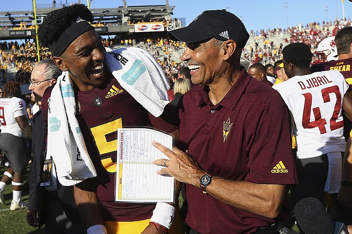 Arizona State quarterback Jayden Daniels (5) celebrates with head coach Herm Edwards, right, after an NCAA college football game win over Washington State, Saturday, Oct. 12, 2019, in Tempe. (Ross D. Franklin/AP, file)