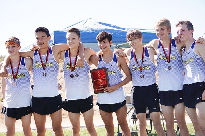 The Prescott boys cross-country team holds up its plaque after taking first place in the Bradshaw Mountain Invitational on Saturday, Oct. 19, 2019, at Bradshaw Mountain Middle School. (Aaron Valdez/Courier)