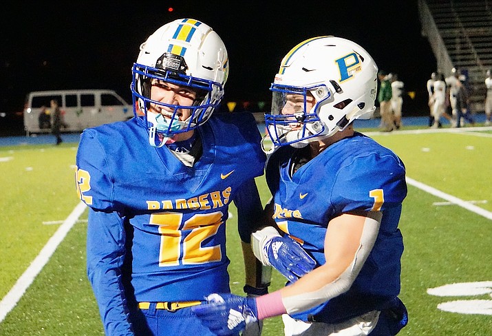 Brayden Nelson (12) celebrates with Sylas Espitia (1) after Nelson scored a touchdown against Mohave on Friday, Oct. 18, 2019, in Prescott. The Badgers won 56-0. (Aaron Valdez/Courier)