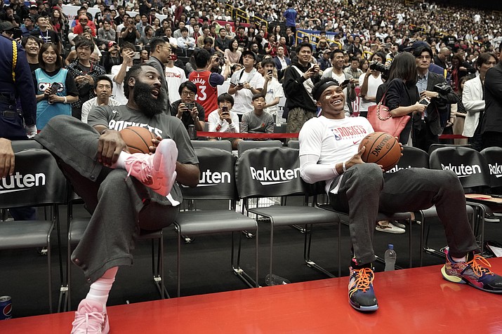 Houston Rockets’ James Harden, left, and Russell Westbrook share a light moment during warmups for the team’s NBA preseason basketball game against the Toronto Raptors Oct. 10, 2019, in Saitama, near Tokyo. (Jae C. Hong/AP, file)