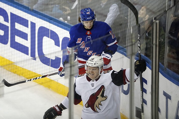 Arizona Coyotes left wing Christian Dvorak (18) celebrates his overtime goal, as New York Rangers center Artemi Panarin (10) looks down, at the end of an NHL hockey game Tuesday, Oct. 22, 2019, in New York. The Coyotes won 3-2. (Kathy Willens/AP)