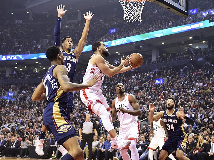 Toronto Raptors guard Fred VanVleet (23) goes to the basket as New Orleans Pelicans’ Josh Hart (3) and Nickeil Alexander-Walker (0) defend during the first half of an NBA basketball game Tuesday, Oct. 22, 2019, in Toronto. (Frank Gunn/The Canadian Press via AP)