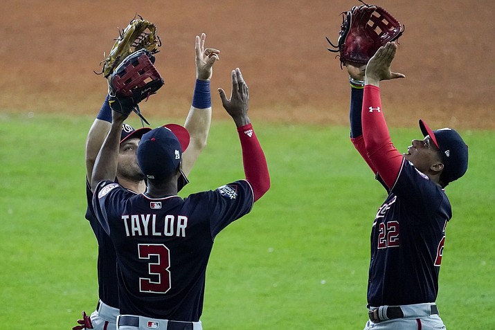 Washington Nationals' Gerardo Parra, Michael A. Taylor and Juan Soto celebrate after Game 2 of the baseball World Series against the Houston Astros Thursday, Oct. 24, 2019, in Houston. The Nationals won 12-3 to take a 2-0 lead in the series. (Eric Gay/AP)