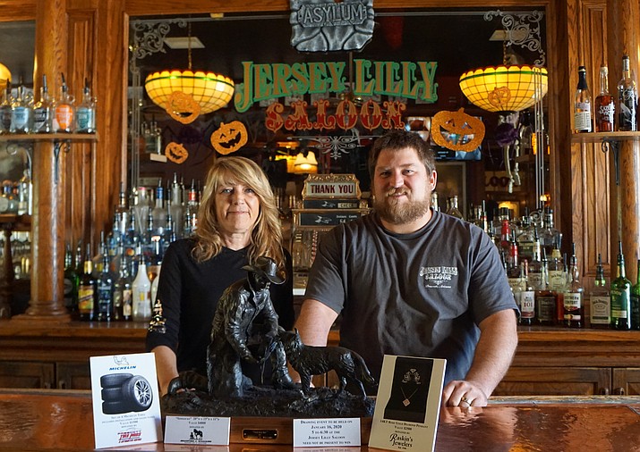 Susan Roberts and Josh Makrauer show the prizes available in this year’s annual Friends of Jersey Lilly Fundraiser for the Courthouse Lighting. Along with a bronze sculpture donated by local artist Bradford Williams, the drawing will feature a rose gold diamond pendant donated by Raskin’s Jewelers and a set of new tires from Prescott Tire Pros. (Cindy Barks/Courier)