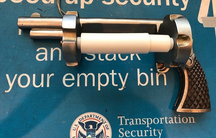 This photo provided by Transportation Security Administration shows a gun-shaped toilet paper holder that was confiscated at checkpoint at Newark Liberty International Airport in Newark, N.J. Agents on Tuesday thought there was a gun in the bag when they put it through the X-ray machine. However, a closer inspection revealed a gun-shaped toilet paper roller. The realistic replica gun was designed to spin paper instead of bullets. Travelers are not permitted to bring real or replica firearms through security checkpoints. (Transportation Security Administration via AP)