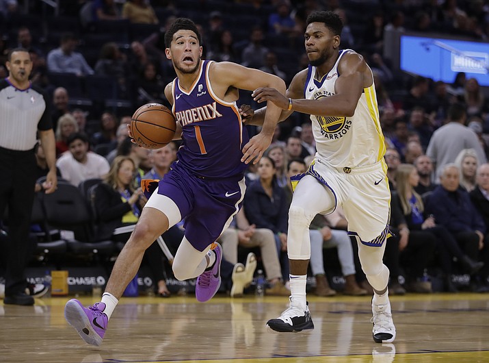 Phoenix Suns' Devin Booker, left, drives the ball past Golden State Warriors' Glenn Robinson III during the second half of a game Wednesday, Oct. 30, 2019, in San Francisco. (Ben Margot/AP)