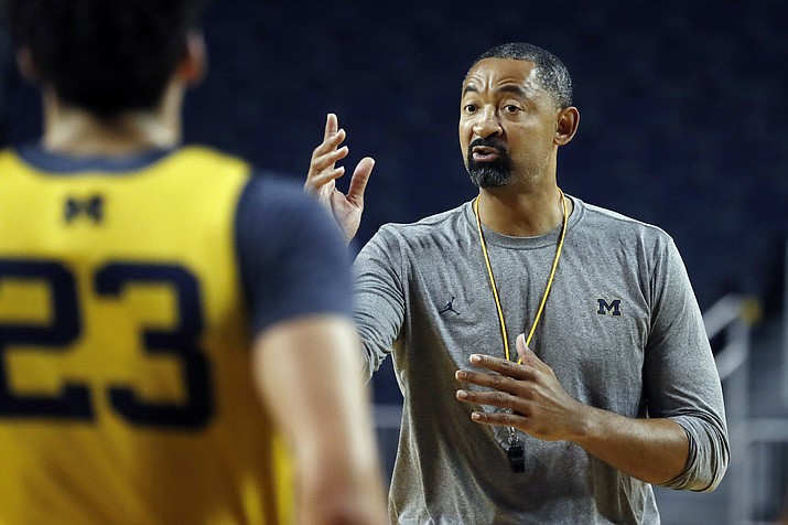 In this Thursday, Oct. 17, 2019, file photo, Michigan head coach Juwan Howard directs his team during NCAA college basketball practice in Ann Arbor, Mich. Howard took over his former team when he replaced John Beilein at Michigan. (Carlos Osorio/AP, file)