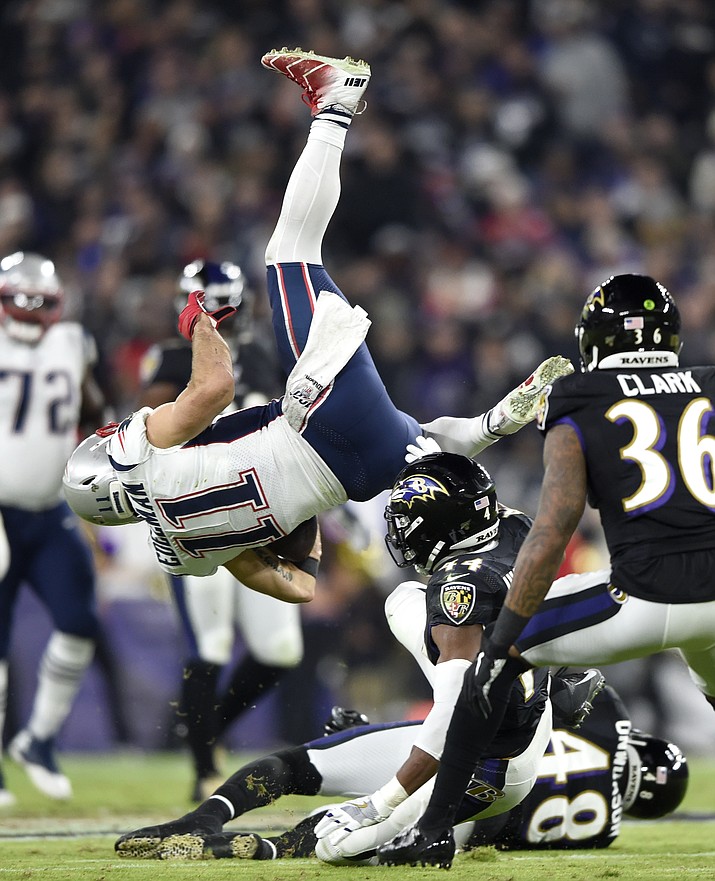 New England Patriots wide receiver Julian Edelman (11) is upended as he collides with Baltimore Ravens cornerback Marlon Humphrey (44) during the first half of an NFL football game, Sunday, Nov. 3, 2019, in Baltimore. (AP Photo/Gail Burton)