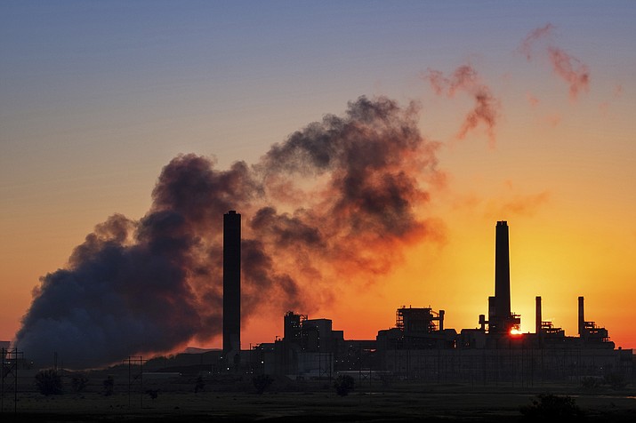 In this July 27, 2018 photo, the Dave Johnson coal-fired power plant is silhouetted against the morning sun in Glenrock, Wyo. The Trump administration is proposing easing more Obama-era protections on contaminants from coal-fired power plants. Environmental Protection Agency administrator Andrew Wheeler signed a proposal Monday overhauling a 2015 rule on release of contaminated wastewater from power plants. The EPA says the change will save $175 million annually in compliance costs.(J. David Ake/AP)