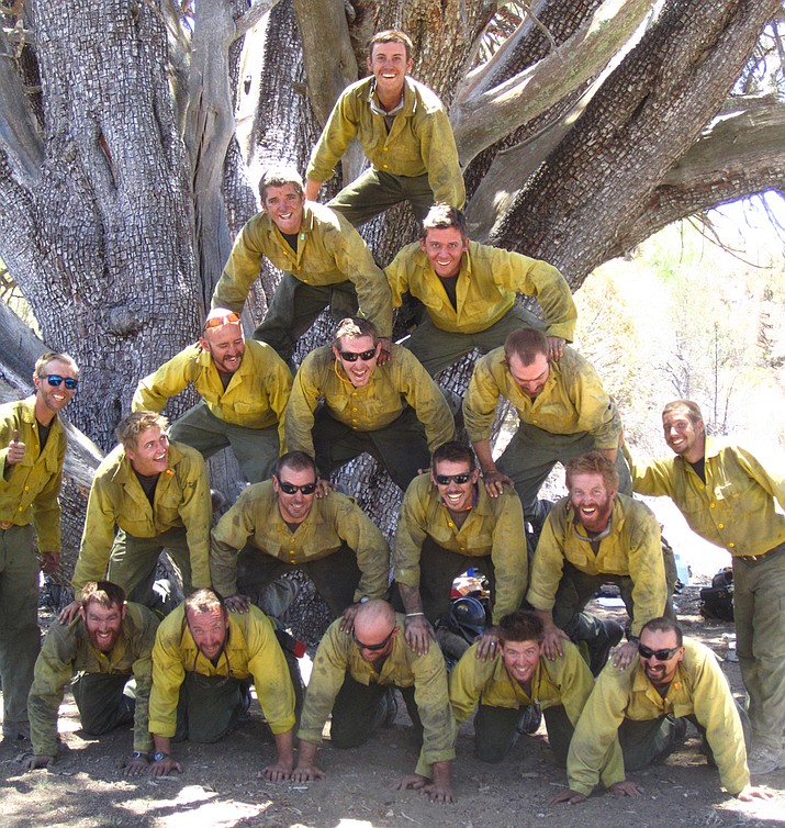 The Granite Mountain Hotshots form a pyramid in front of an ancient alligator juniper tree during the June 2013 Doce fire. (Courtesy)