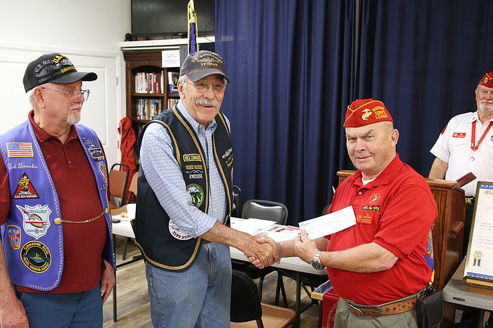 On behalf of Prescott’s Gudgeon base of the United States Submarine Veterans, Inc., Vice Base Commander Dennis McCreight, left, presents a donation of $150 to Toys for Tots. (Courtesy/Dennis McCreight)