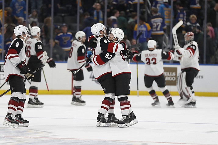 Arizona Coyotes’ Conor Garland (83) is congratulated by Jordan Oesterle (82) after scoring the game-winning goal during a shootout of a game against the St. Louis Blues Tuesday, Nov. 12, 2019, in St. Louis. The Coyotes won 3-2. (Jeff Roberson/AP)