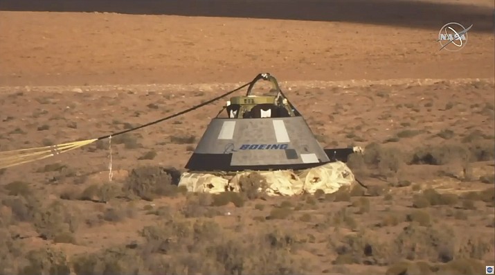 In this image made from a video provided by NASA the Starliner capsule rests on the ground after a test of Boeing's crew capsule launch abort system in White Sands Missile Range in N.M., on Monday, Nov. 4, 2019. Cochise County Arizona officials are hearing about possible emergency responses and road closures that might be required if the new reusable space capsule lands by parachute on a flat desert grassland (NASA via AP)