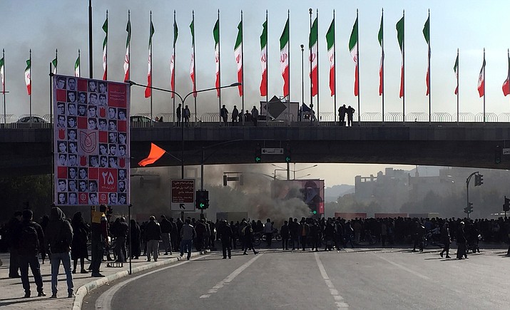 Smoke rises during a protest after authorities raised gasoline prices, in the central city of Isfahan, Iran, Saturday, Nov. 16, 2019. Demonstrators angered by a 50% increase in government-set gasoline prices blocked traffic in major cities and occasionally clashed with police Saturday after a night of demonstrations punctuated by gunfire. (AP Photo)