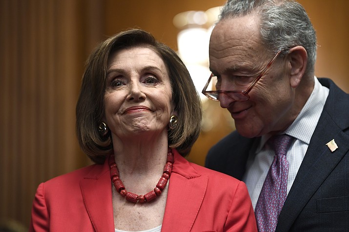 House Speaker Nancy Pelosi of Calif., left, and Senate Minority Leader Sen. Chuck Schumer of N.Y., right, listen as they wait to speak at an event on Capitol Hill in Washington, Tuesday, Nov. 12, 2019, regarding the earlier oral arguments before the Supreme Court in the case of President Trump's decision to end the Obama-era, Deferred Action for Childhood Arrivals (DACA), program. (AP Photo/Susan Walsh)
