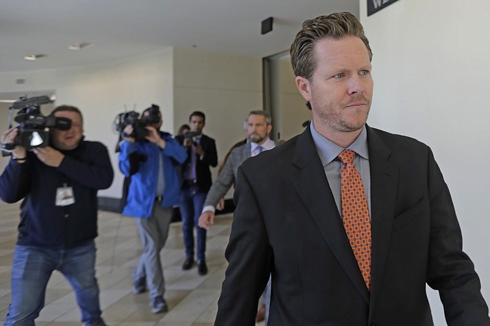 In this Nov. 15, 2019, file photo, Paul Petersen, an Arizona elected official accused of running a multi-state adoption scheme, leaves court following an initial appearance on charges filed in the state in Salt Lake City. Officials in Arizona have hired two law firms and a former attorney general to investigate an elected county assessor who is trying to keep his job as he defends himself against human smuggling charges. Maricopa County Attorney Allister Adel said Tuesday, Nov. 19, 2019, that the lawyers will investigate Maricopa County Assessor Paul Petersen's conduct in office as he contests a 120-day suspension. (AP Photo/Rick Bowmer, File)