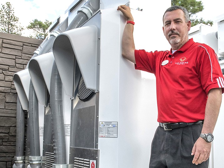 Grand Hotel General Manager stands next to the APS transformers that are used to charge the charger stations. The hotel is not connected to the transformers. (Veronica R. TierneyWGCN)