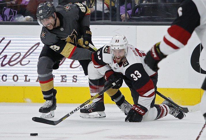 Vegas Golden Knights right wing Alex Tuch (89) and Arizona Coyotes defenseman Alex Goligoski (33) vie for the puck during the second period of a game Friday, Nov. 29, 2019, in Las Vegas. (John Locher/AP)