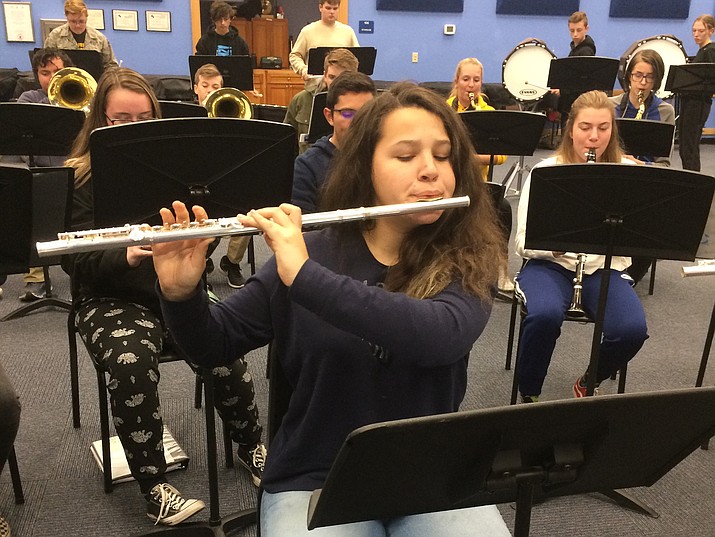 Prescott High sophomore flute player Makenna Koopman plays one of the patriotic tunes the Pride of Prescott Marching Band practiced in a special 90-minute practice on the Monday night before Thanksgiving. The band will be performing a series of “salutes” and medleys of America-themed music. (Nanci Hutson/Courier)