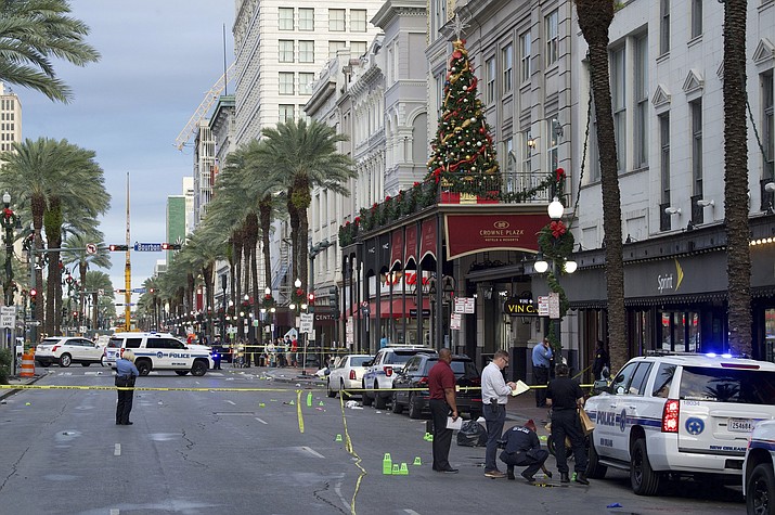 New Orleans police investigate the scene of a shooting Sunday, Dec. 1, 2019, on the edge of the city's famed French Quarter. (Max Becherer/The Times-Picayune/The New Orleans Advocate via AP)