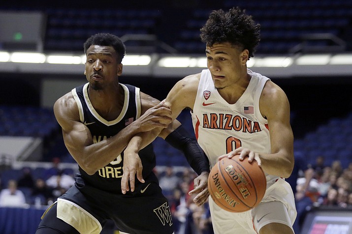 Arizona guard Josh Green, right, drives to the basket against Wake Forest guard Andrien White during the first half of an NCAA college basketball game at the Wooden Legacy tournament in Anaheim, Calif., Sunday, Dec. 1, 2019. (AP Photo/Alex Gallardo)