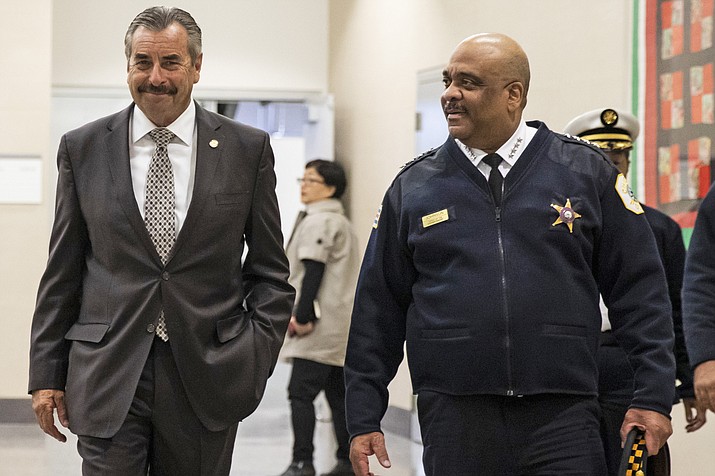 FILE - In this Nov. 8, 2019 file photo, Chicago's interim Police Superintendent Charlie Beck, left, walks through CPD headquarters with retiring Police Superintendent Eddie Johnson, in Chicago. Chicago Mayor Lori Lightfoot fired Police Supt. Eddie Johnson on Monday, Dec. 2, 2019, saying her decision was based his "ethical lapses." Lightfoot said she decided to fire Johnson after reviewing an inspector general's report on its investigation into a recent incident in which he was found asleep behind the wheel of his SUV. (Ashlee Rezin Garcia/Chicago Sun-Times via AP, File)