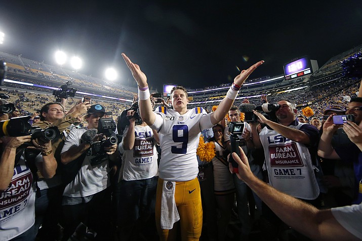 In this Nov. 30, 2019, photo, LSU quarterback Joe Burrow (9) gestures thanks to the student section after playing his last game in Tiger Stadium, a game against Texas A&M, in Baton Rouge, La. (Gerald Herbert/AP, file)