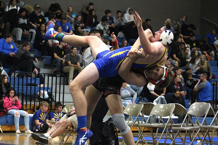 Lee Williams senior Jimmy Wayman throws his Prescott opponent to the mat Wednesday during a dual match at Kingman High School. Wayman tallied a 13-1 victory in the match on his way to a perfect 3-0 day. (Photo by Beau Bearden/Kingman Miner)