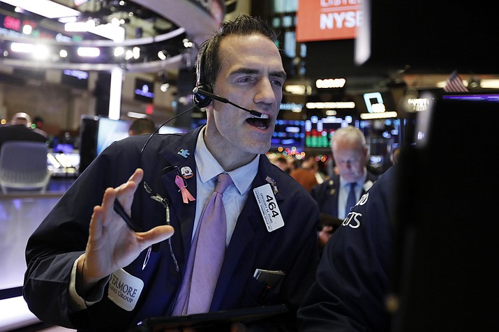 Trader Gregory Rowe works on the floor of the New York Stock Exchange, Friday, Dec. 13, 2019. After months of waiting, markets had a muted reaction to news that the US and China had reached an initial deal on trade. (Richard Drew/AP)