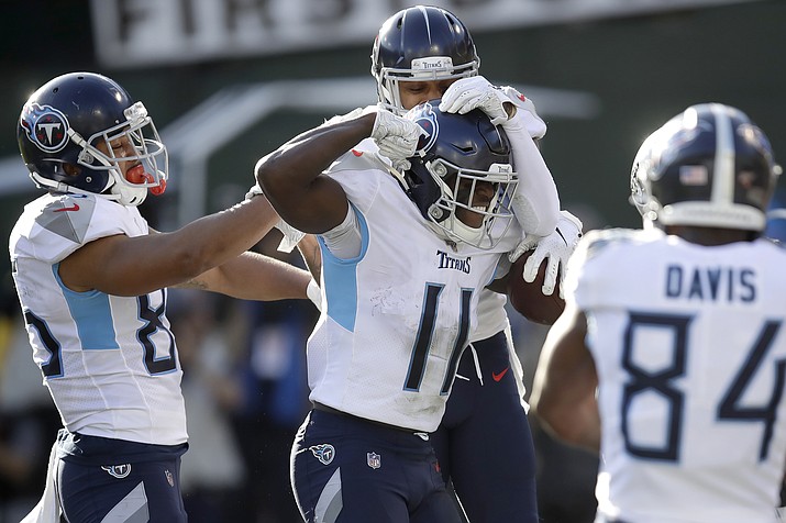 Tennessee Titans wide receiver A.J. Brown (11) is congratulated by teammates after scoring against the Oakland Raiders during the first half of a game in Oakland, Calif., Sunday, Dec. 8, 2019. (Ben Margot/AP)