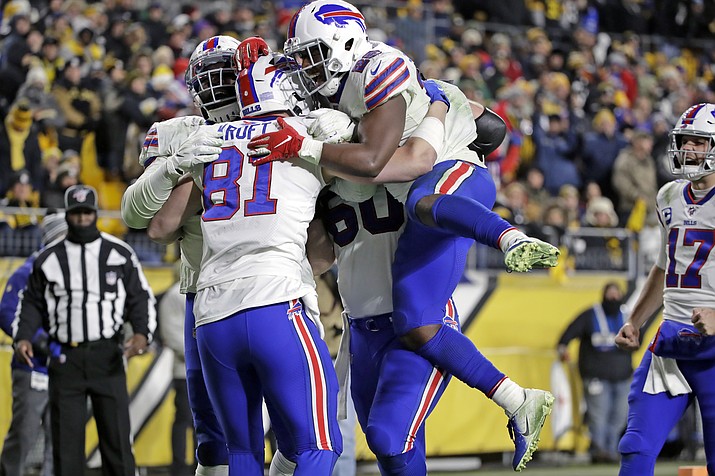 Buffalo Bills tight end Tyler Kroft (81) celebrates with running back Devin Singletary (26) and others after scoring on a pass from quarterback Josh Allen during the second half of an NFL football game against the Pittsburgh Steelers in Pittsburgh, Sunday, Dec. 15, 2019. (AP Photo/Don Wright)