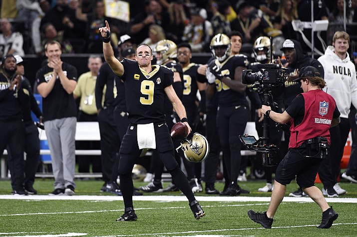 New Orleans Saints quarterback Drew Brees (9) celebrates his touchdown pass to tight end Josh Hill, which broke the NFL record for career touchdown passes, surpassing Peyton Manning, in the second half of an NFL football game against the Indianapolis Colts in New Orleans, Monday, Dec. 16, 2019. (AP Photo/Bill Feig)