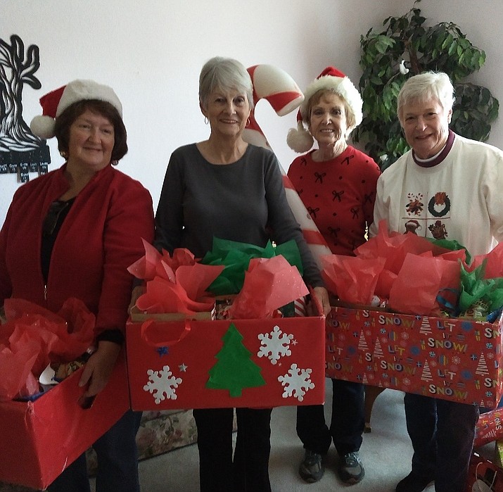 From left, Judy Davies, Bev Stuart-Borok, Dorothy Castanos and Sue Burk pass out gifts to students at Mayer Elementary School on Dec. 18, 2019.  (DAR/Courtesy)