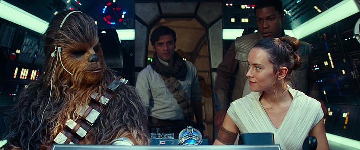 This image released by Disney/Lucasfilm shows, from left, Joonas Suotamo as Chewbacca, Oscar Isaac as Poe Dameron, Daisy Ridley as Rey and John Boyega as Finn in a scene from “Star Wars: The Rise of Skywalker.” (Disney/Lucasfilm Ltd. via AP)