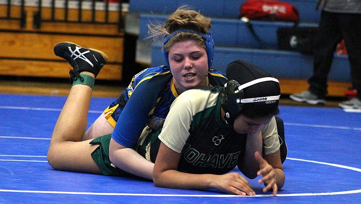 Kingman High’s Jordan Gessey wrestles her Mohave opponent Wednesday during a four-team dual meet at KHS. Gessey wouldn’t win this match, but did pin her River Valley opponent. (Photo by Beau Bearden/Kingman Miner)