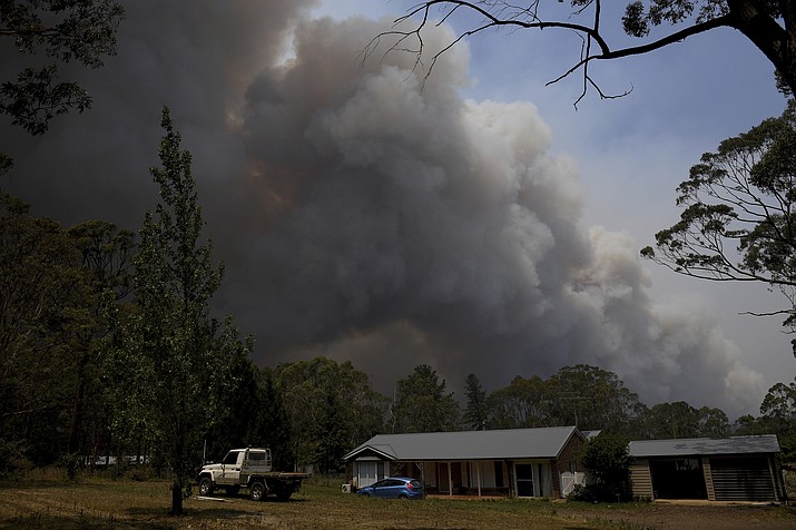 A home stands as smoke from the Grose Valley fire rises in the distance in Bilpin, west of Sydney, Saturday, Dec. 21, 2019. Australia’s most populous state has been paralyzed by “catastrophic” fire conditions Saturday amid souring temperatures as wildfires also ravaged the country’s southeast. (Dan Himbrechts/AP)