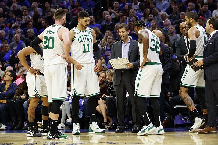 In this Oct. 23, 2019, file photo, Boston Celtics head coach Brad Stevens, center, talks things over with his team during the second half of a game against the Philadelphia 76ers in Philadelphia. Many coaches are striking the delicate balance between pushing inexperienced players enough for the players and the team to have success while realizing that the learning curve in the league is often a long one.  (Chris Szagola/AP, file)