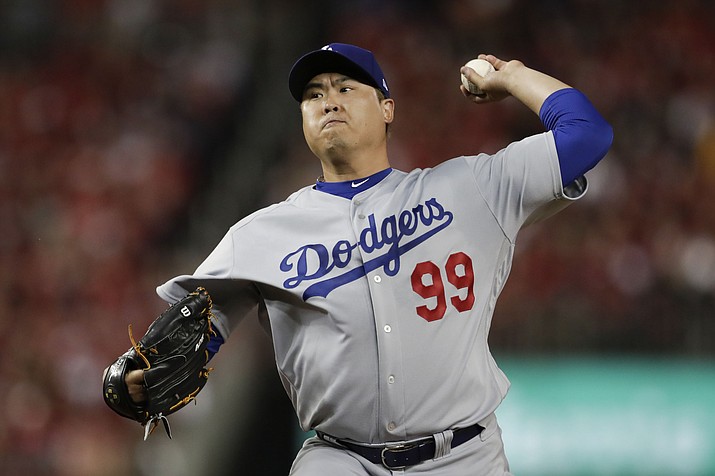 In this Oct. 6, 2019, photo, Los Angeles Dodgers starting pitcher Hyun-Jin Ryu throws to a Washington Nationals batter during Game 3 of a baseball National League Division Series in Washington. (Julio Cortez/AP, File)