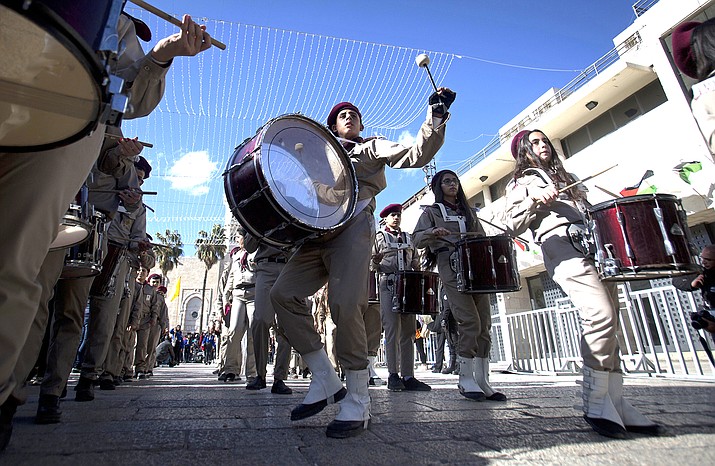 A Palestinian Scout marching band parades during Christmas celebrations outside the Church of the Nativity, built atop the site where Christians believe Jesus Christ was born, on Christmas Eve, in the West Bank City of Bethlehem Dec. 24. (AP Photo/Majdi Mohammed)