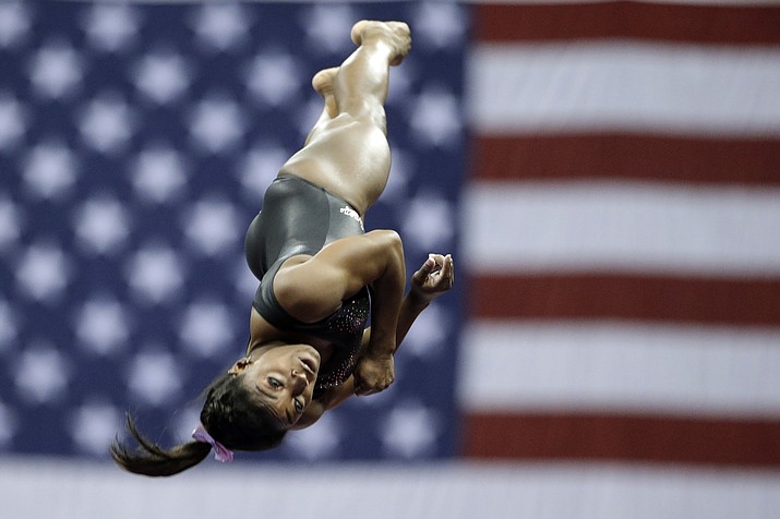 This Aug. 11, 2019, file photo shows Simone Biles practicing on vault for the senior women's competition at the 2019 U.S. Gymnastics Championships in Kansas City, Mo. Biles is the 2019 AP Female Athlete of the Year. She is the first gymnast to win the award twice and the first to win it in a non-Olympic year. (Charlie Riedel/AP, file)