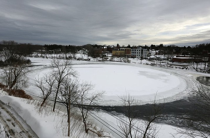 In this Jan. 23, 2019 file photo, a naturally occurring, slowly spinning ice disk the width of a football field floats in the Presumpscot River in Westbrook, Maine. The story of the rotating frozen is among some of 2019's weirder stories in New England. (AP Photo/Robert F. Bukaty, File)